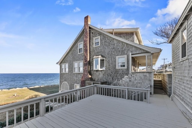 wooden terrace featuring a water view