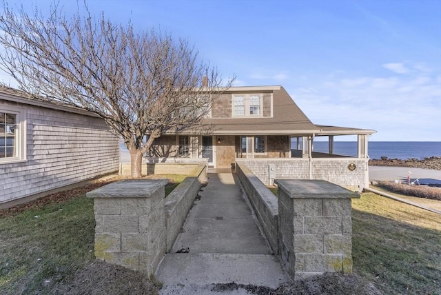 view of front facade with a water view and a front yard