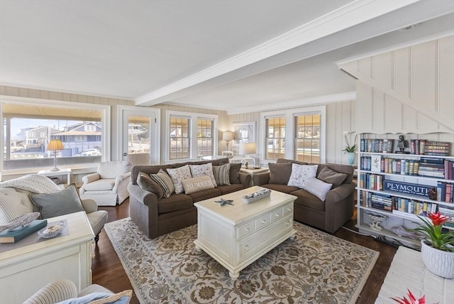 living room featuring beamed ceiling, dark hardwood / wood-style flooring, and crown molding