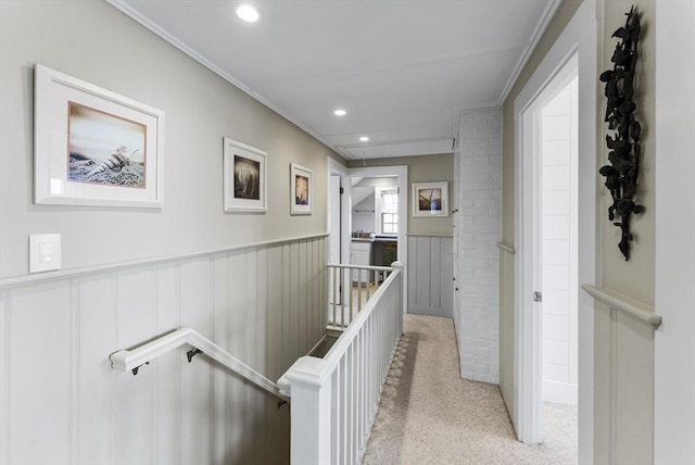 hall featuring light carpet and ornamental molding