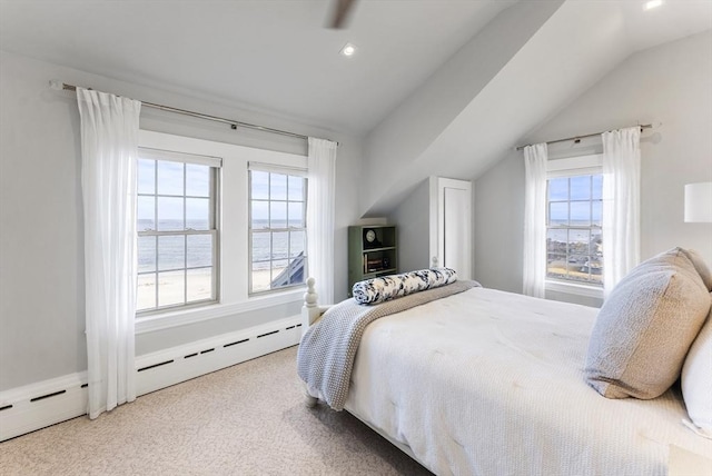 bedroom with carpet flooring, a water view, vaulted ceiling, and multiple windows