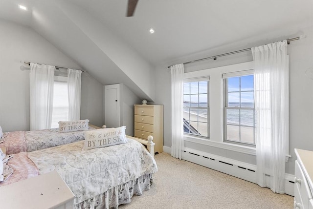 bedroom with a water view, light colored carpet, a baseboard radiator, and vaulted ceiling