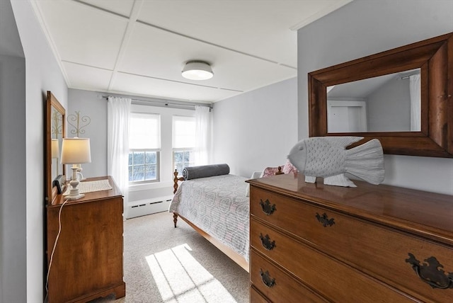 bedroom featuring light carpet and a baseboard heating unit