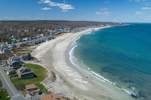 birds eye view of property with a view of the beach and a water view