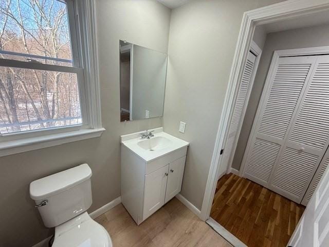 bathroom featuring vanity, hardwood / wood-style floors, and toilet