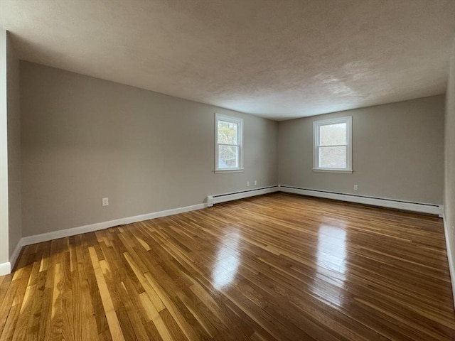 spare room with hardwood / wood-style flooring and a textured ceiling