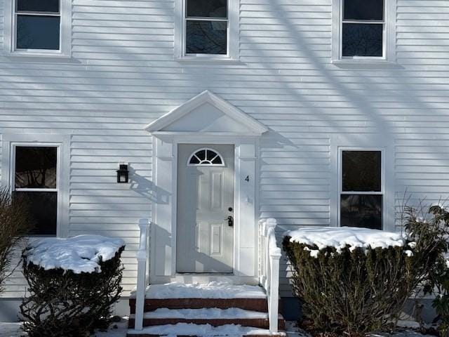 view of snow covered property entrance