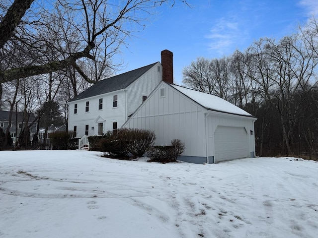 view of snow covered exterior featuring a garage