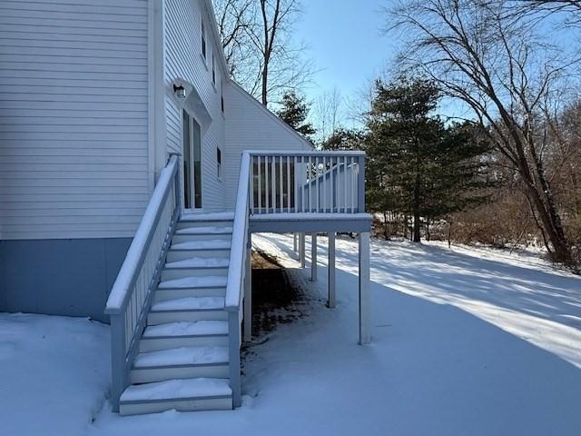 view of snowy exterior featuring a wooden deck