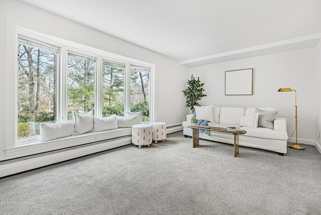 carpeted living room featuring baseboard heating, a healthy amount of sunlight, a baseboard heating unit, and baseboards