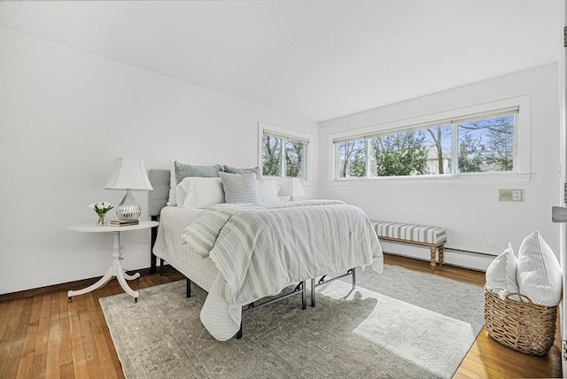 bedroom with baseboards and wood-type flooring