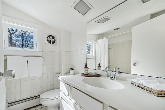 full bathroom featuring tile walls, toilet, vaulted ceiling, baseboard heating, and vanity