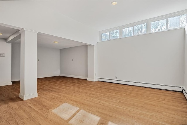 interior space with light wood-style flooring, baseboards, and baseboard heating