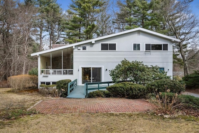 rear view of house featuring a sunroom