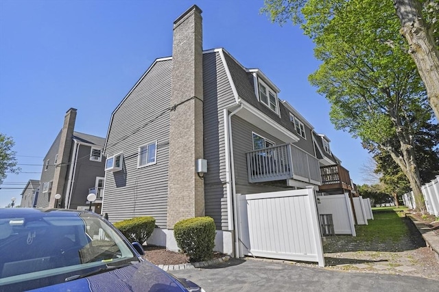 view of property exterior with a chimney