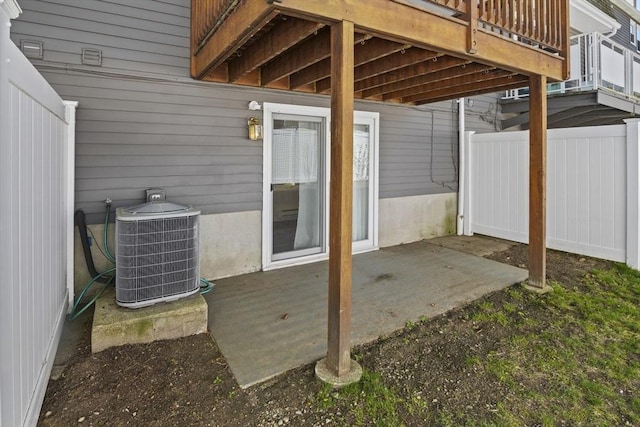 view of patio featuring fence and cooling unit