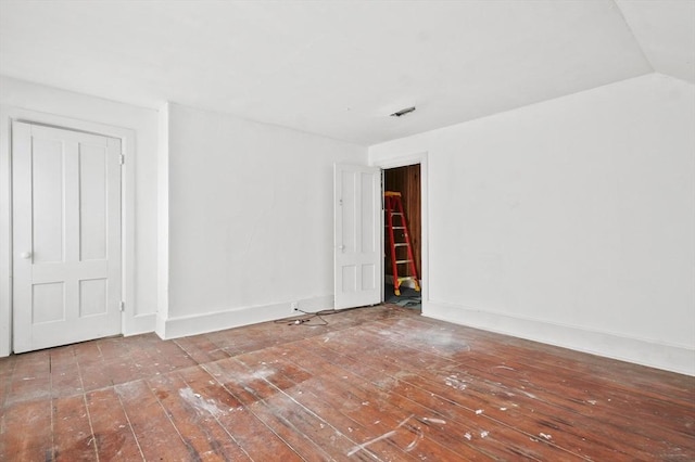 unfurnished room featuring hardwood / wood-style floors and baseboards