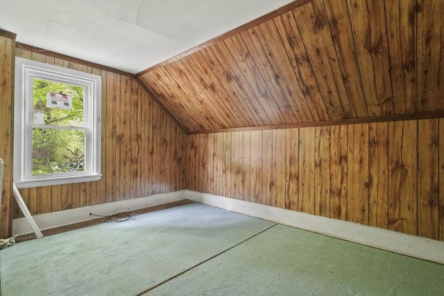 bonus room with lofted ceiling and wooden walls