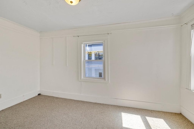 spare room featuring light colored carpet