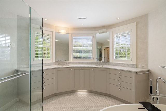 bathroom featuring a shower stall, vanity, and tile patterned floors