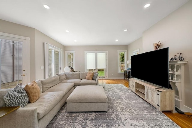 living room with light wood finished floors, recessed lighting, and baseboards