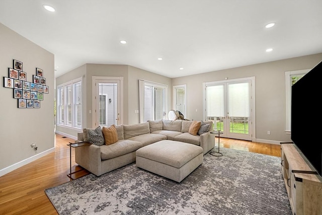 living area with light wood-style floors, recessed lighting, baseboards, and french doors