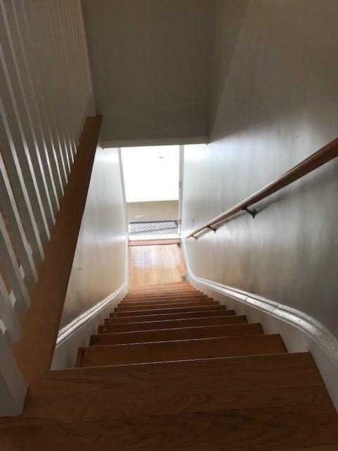 stairway featuring wood finished floors