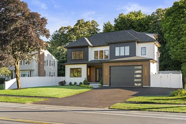 view of front of home with a garage and a front lawn