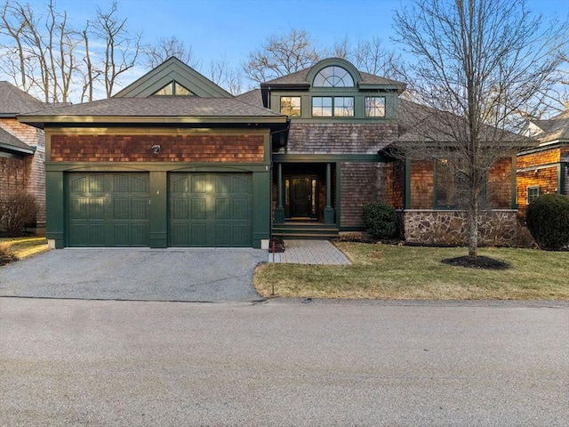 view of front facade featuring aphalt driveway, a front yard, a garage, and roof with shingles