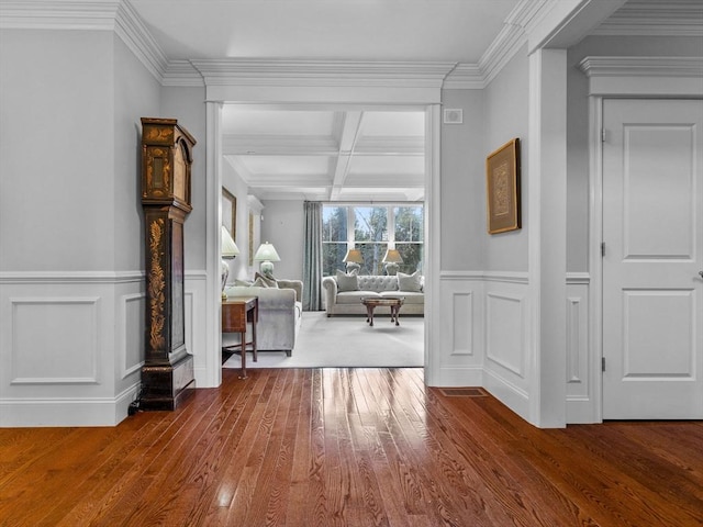 corridor featuring beam ceiling, hardwood / wood-style flooring, coffered ceiling, and ornamental molding