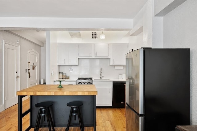 250 Beacon Unit 1B, Boston, MA 02116 - kitchen featuring freestanding refrigerator, a sink, black dishwasher, stove, and light wood finished floors