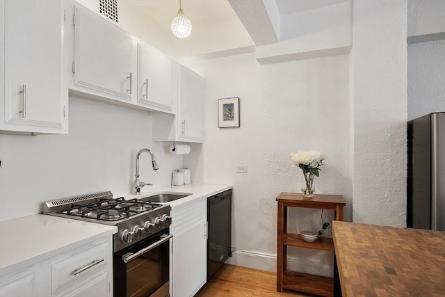 250 Beacon Unit 1B, Boston, MA 02116 - kitchen with gas stove, a sink, black dishwasher, white cabinetry, and light wood finished floors