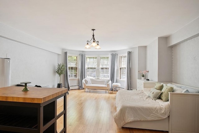 250 Beacon Unit 1B, Boston, MA 02116 - bedroom with light wood-style flooring, a chandelier, a baseboard heating unit, and baseboard heating