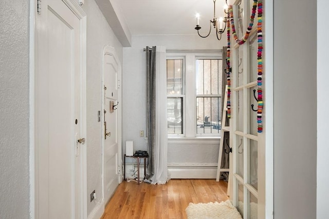 250 Beacon Unit 1B, Boston, MA 02116 - doorway with a chandelier, wood finished floors, and a baseboard heating unit