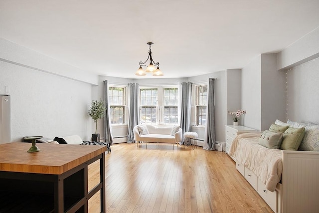 250 Beacon Unit 1B, Boston, MA 02116 - living area featuring light wood-style flooring, a chandelier, and baseboard heating
