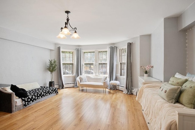 250 Beacon Unit 1B, Boston, MA 02116 - living area featuring light wood-type flooring, a chandelier, and a baseboard radiator