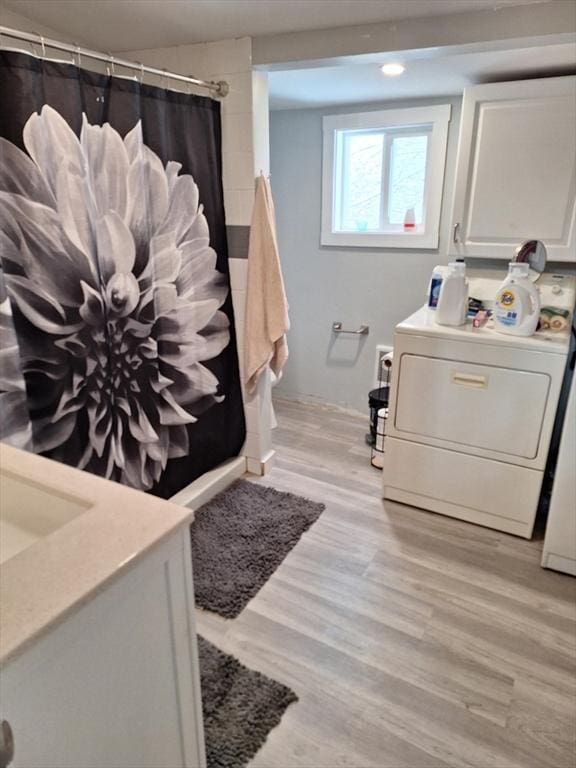 bathroom with vanity, wood-type flooring, and walk in shower