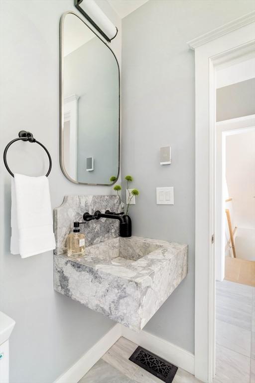 bathroom with baseboards and visible vents