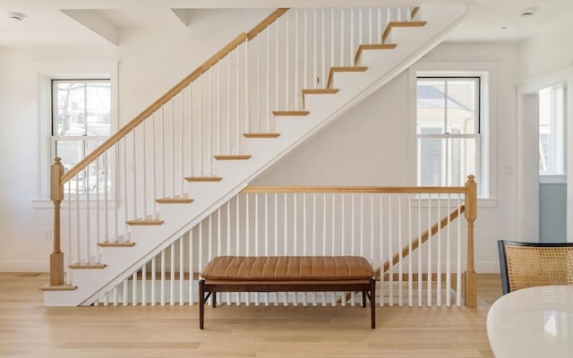 stairs featuring baseboards and wood finished floors