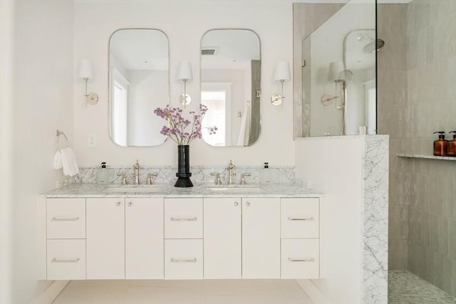 full bathroom with visible vents, a sink, a walk in shower, and double vanity