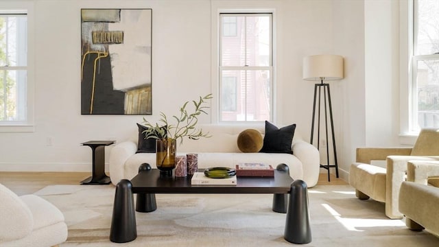 sitting room featuring a healthy amount of sunlight and wood finished floors