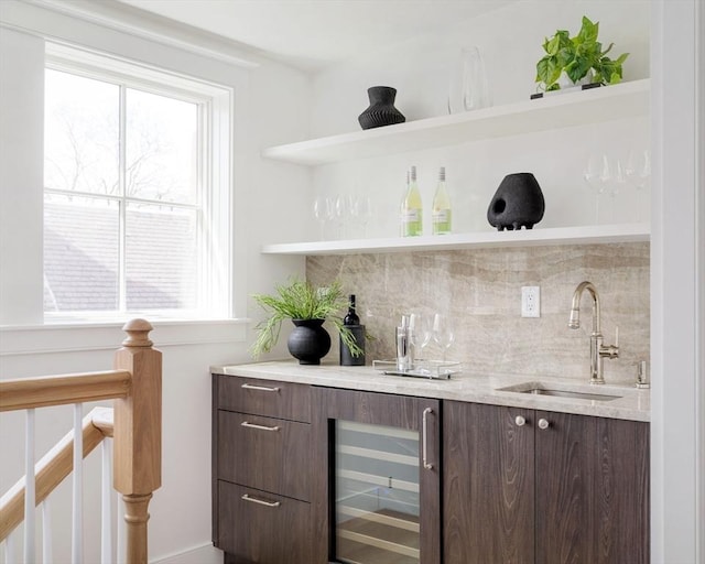 bar featuring a healthy amount of sunlight, backsplash, a sink, indoor wet bar, and wine cooler
