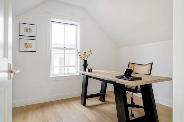 office with plenty of natural light, baseboards, light wood-style flooring, and lofted ceiling