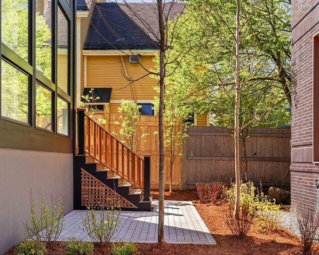 exterior space featuring a patio, fence, and stairs
