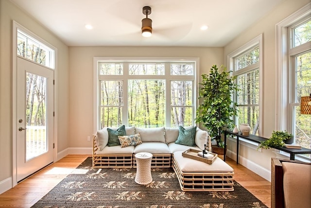 sunroom / solarium featuring ceiling fan