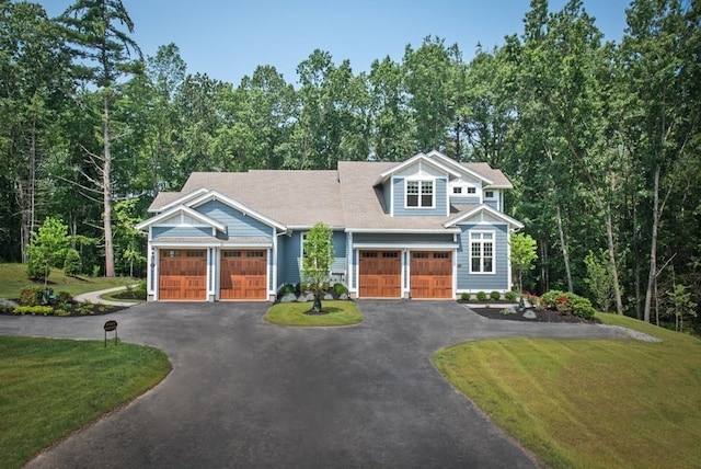 view of front of home with a front yard and a garage