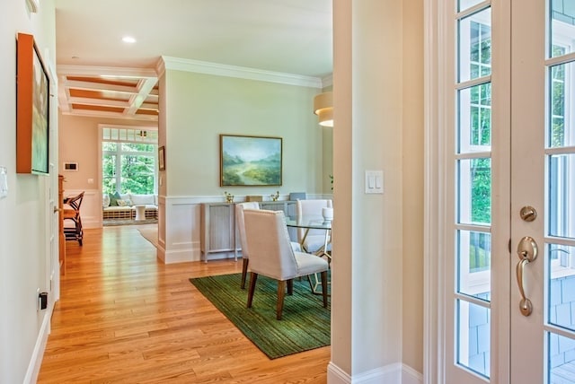 corridor with coffered ceiling, beam ceiling, light wood-type flooring, and ornamental molding