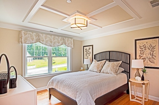 bedroom featuring coffered ceiling and hardwood / wood-style flooring