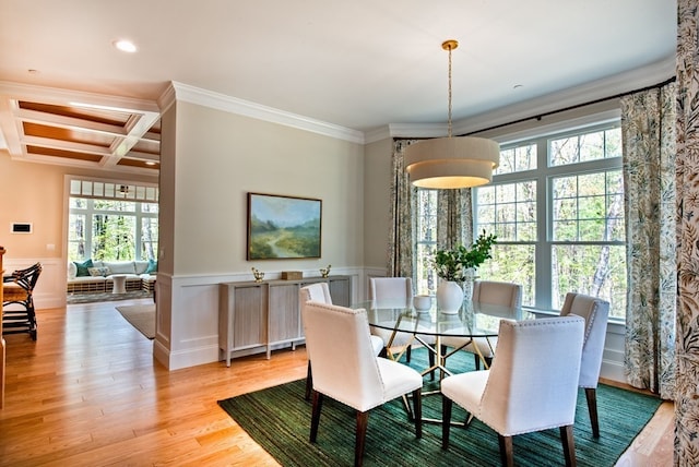 dining space with beam ceiling, coffered ceiling, light hardwood / wood-style flooring, and crown molding