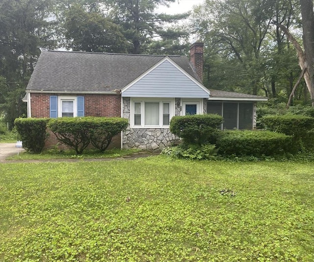 107 Rollins St, Springfield, MA 01109 - bungalow-style home with a chimney, a front lawn, a shingled roof, and stone siding